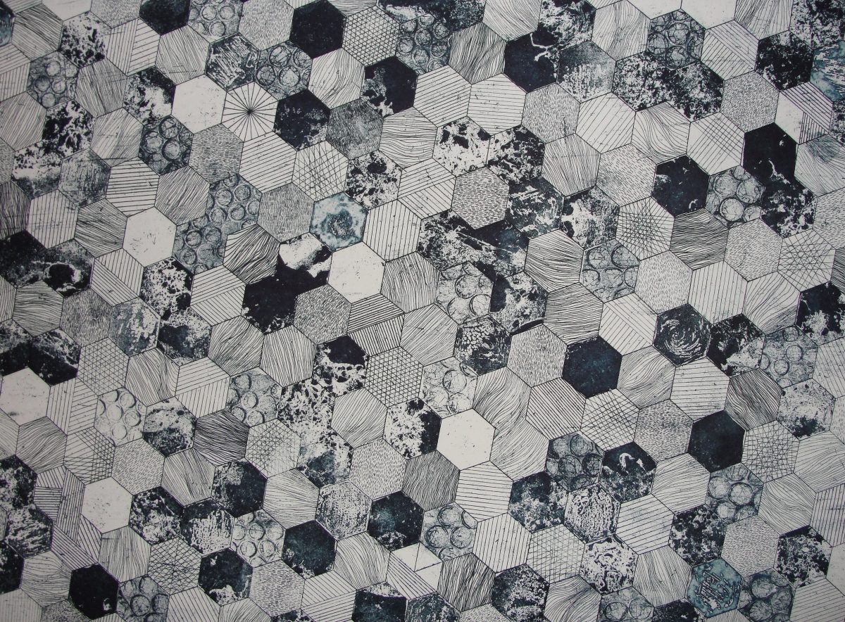 Photo of a tile floor with hexagonal tiles of different patterns of white, gray, and black.
